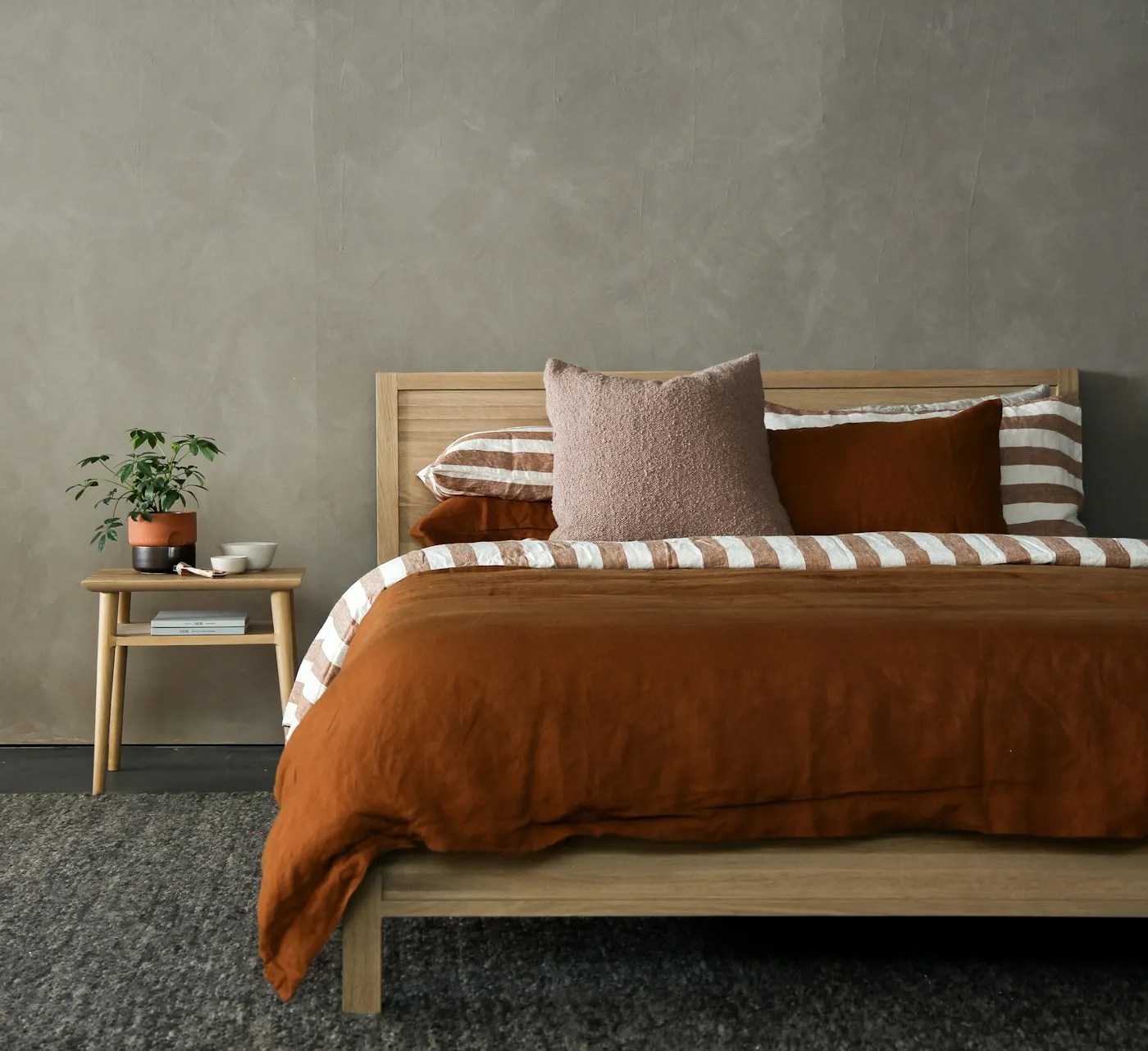 A warm, cozy bedroom with a quality bed — the comfortable sleep BoxDrop sells for 50–80% less