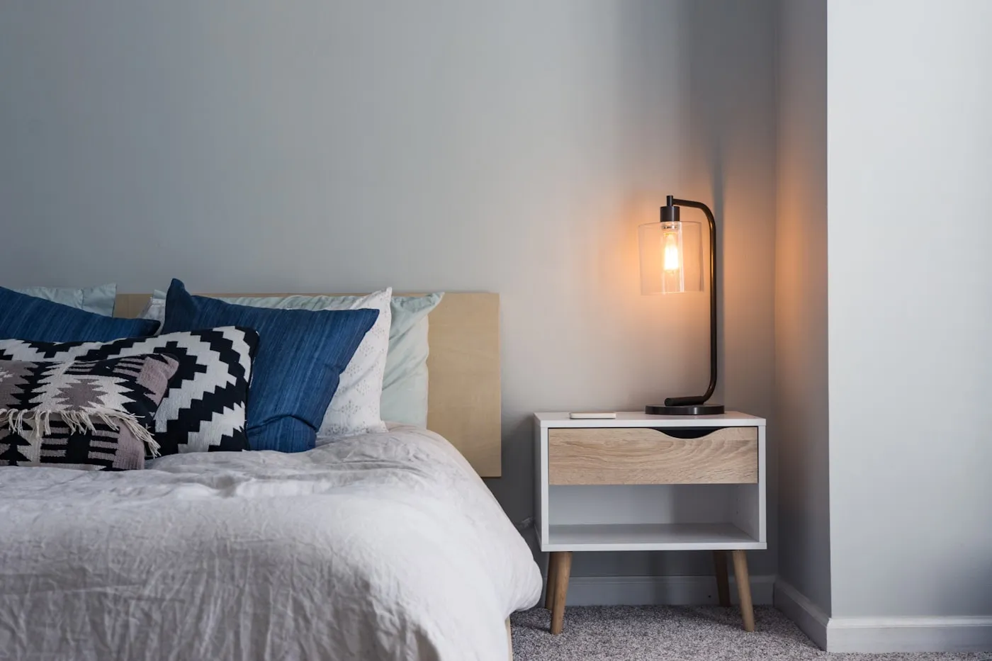 A neatly made bed with quality mattress and pillows